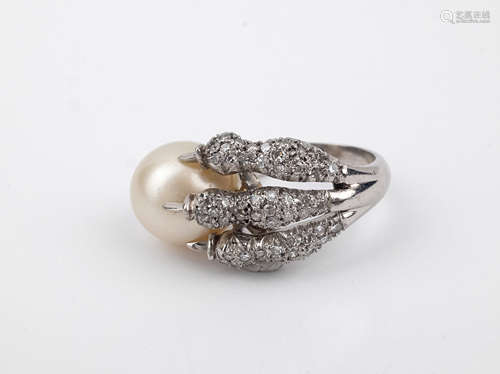 An 18k. white gold, diamonds and a cultured pearl claw shape...