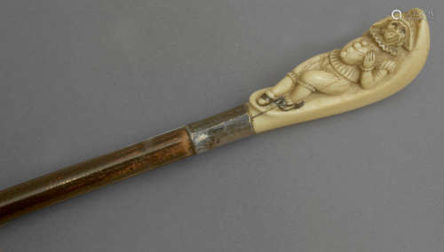 A 19th century walking stick with a silver handle and an ebo...