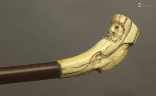 A 19th century walking stick wth a walrus ivory handle and a...