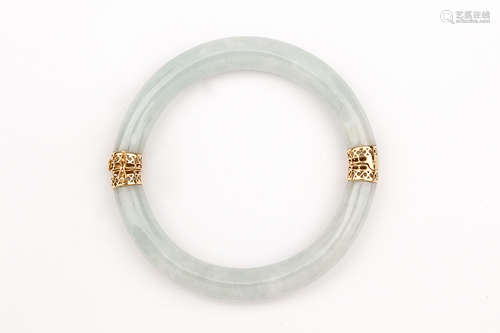 An 18k. yellow gold and white jade gold bangle