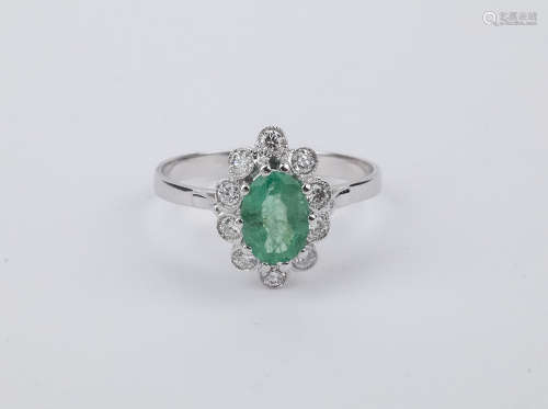 An emerald and brilliant cut diamonds 18k. white gold cluste...