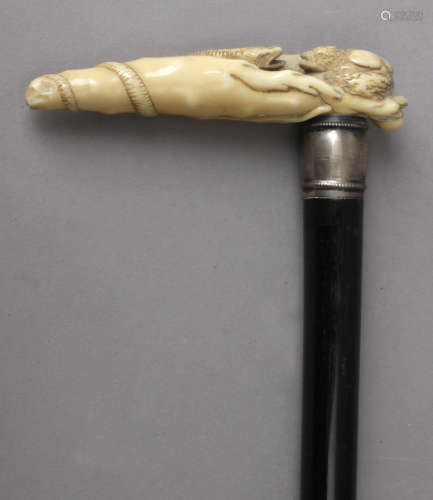 A 19th century possibly English walking stick with a carved ...