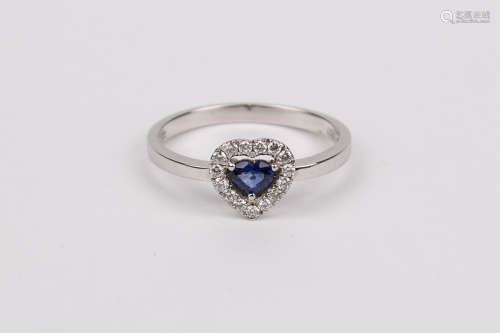 A sapphire and brilliant cut diamonds heart shaped ring
