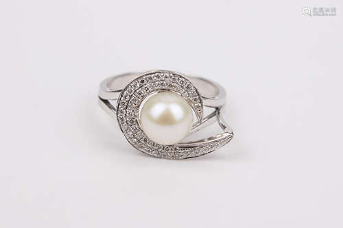 A brilliant cut diamonds and a cultured pearl 18k. white gol...