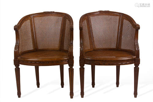 A pair of French Louis XVI style armchairs