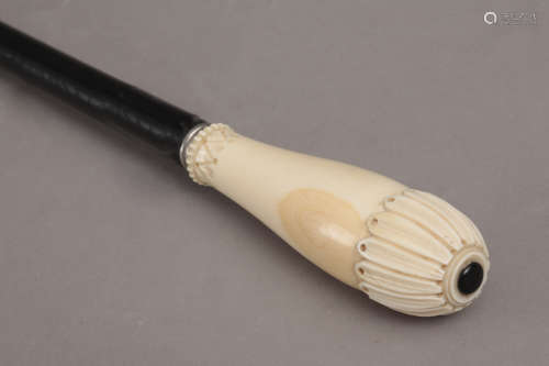 A 19th century walking stick with a carved ivory handle and ...