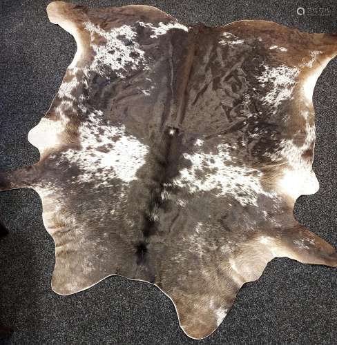 A Large cow hide rug. [220cm in length]