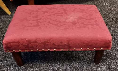 A Vintage red material footstool.