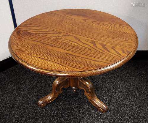 A Reproduction dark wood round side table with heavy carved ...
