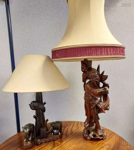A Japanese hand carved wooden figure table lamp together wit...