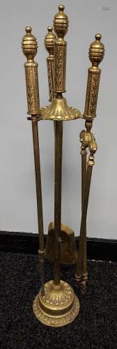 A Heavy ornate brass companion set.