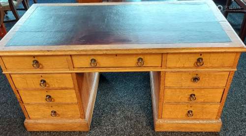 A 19th century light oak and red leather top, knee hole writ...