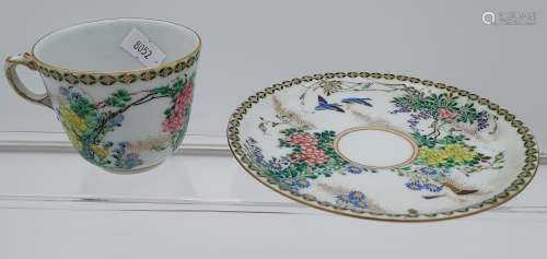 A 19th century Chinese cup and saucer, hand painted with flo...