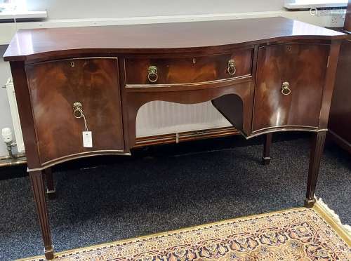 A 19th century serpentine front sideboard. supported on squa...