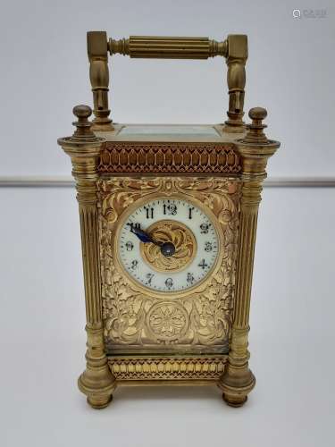 An ornate Antique Gilt brass and bevel glass carriage clock,...