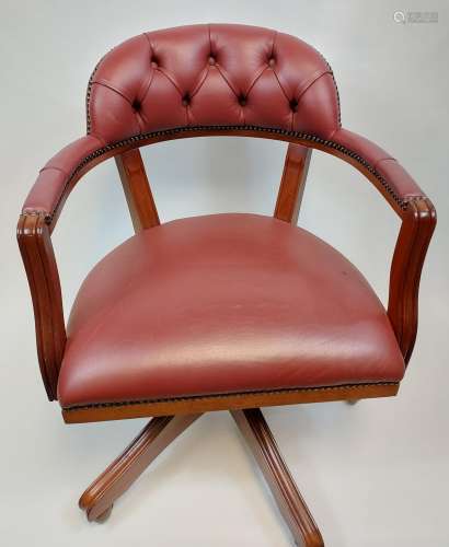 A reproduction chesterfield style captains chair.
