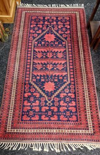 An ornate hand woven Persian rug [206x114cm]