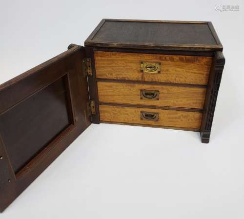 A Miniature Three drawer chest designed with a carved panel ...