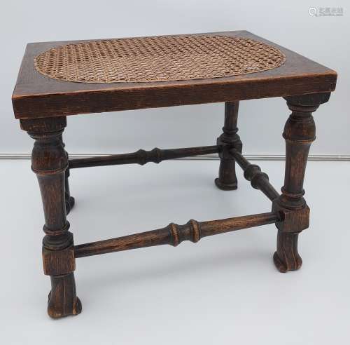 A 19th century oak and bergere top stool. Designed with unus...