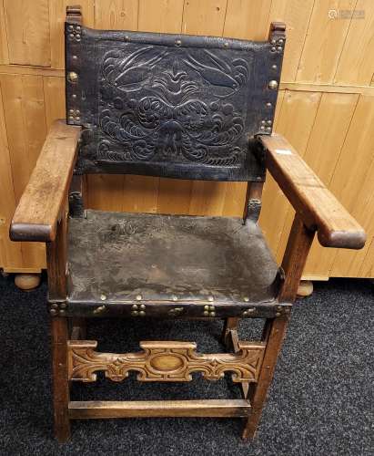 An 18th/ early 19th century fire side arm chair. Leather wor...