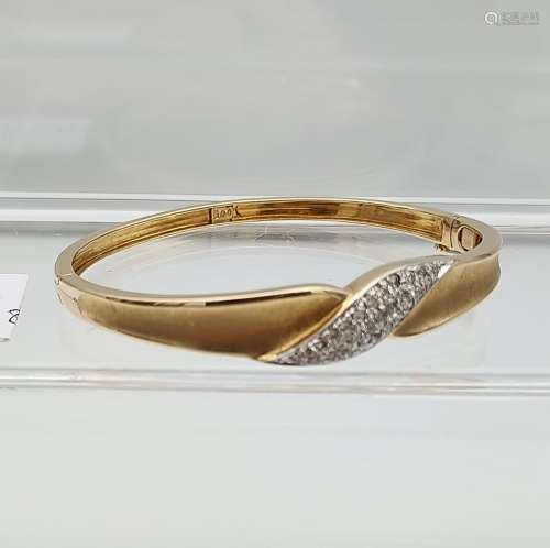 A 14ct yellow gold bangle with pave set diamond band [14.89g...