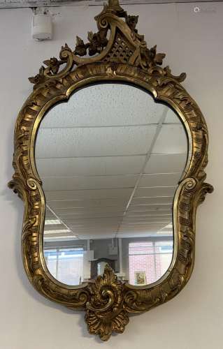 A 18th/ 19th century ornate gilt carved framed wall mirror. ...