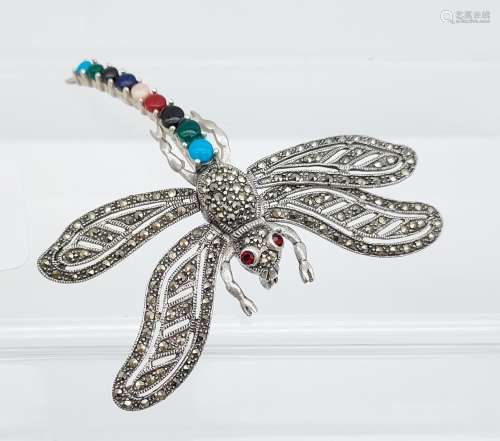 A large dragonfly brooch with ruby eyes & semi precious ston...