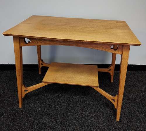 An Arts and crafts light oak two tier window table.