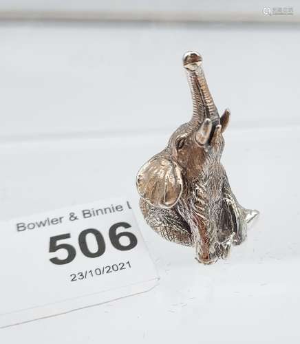A silver figure of a trumpeting elephant. [3.4cm in height]