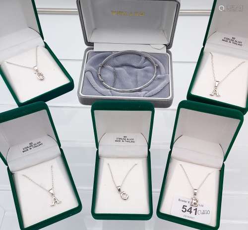 5 Silver Initial pendants with chains together with a silver...