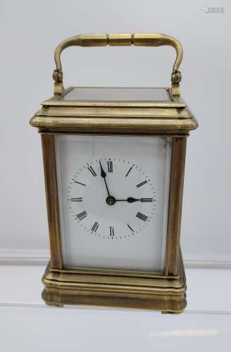 Antique Brass and bevel edge glass carriage clock. In a work...