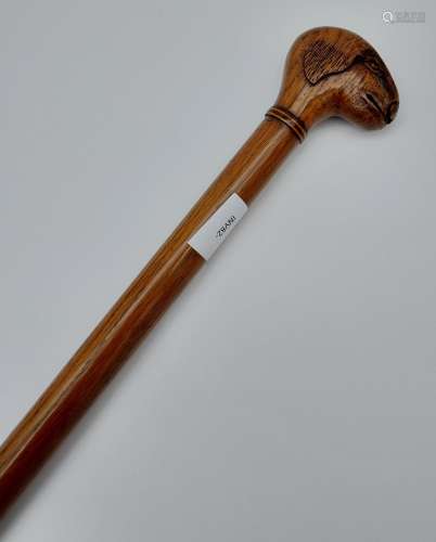 Antique walking stick designed with a hand carved hand in th...