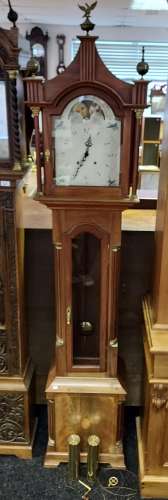 A Reproduction grandfather clock. Comes with weights, pendul...
