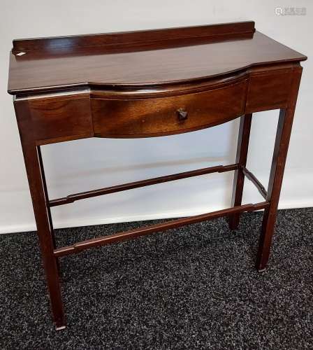 A dark wood console table, with bow front single drawer, rai...