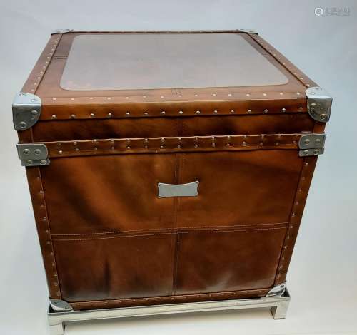 A Contemporary faux leather case/ trunk. Sat upon a chrome p...
