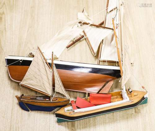 Three wood model boats