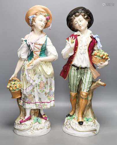 A pair of large Sitzendorf porcelain figures of a maid and a...