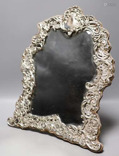 An Edwardian repousse silver mounted easel mirror, with foli...