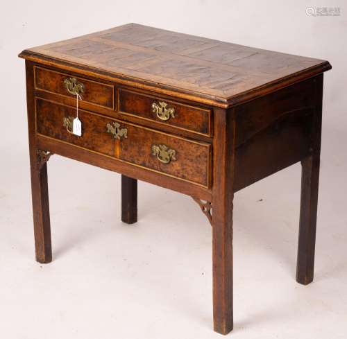 A George III oak and pollard oak three drawer side table, wi...