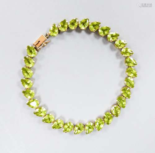 A modern 10k and pear cut peridot set line bracelet, 19cm, g...