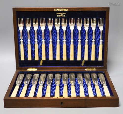 An Edwardian cased set of twelve pairs of ivory handles silv...