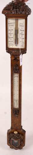 A Victorian carved walnut stick barometer by Chadburn Bros.,...