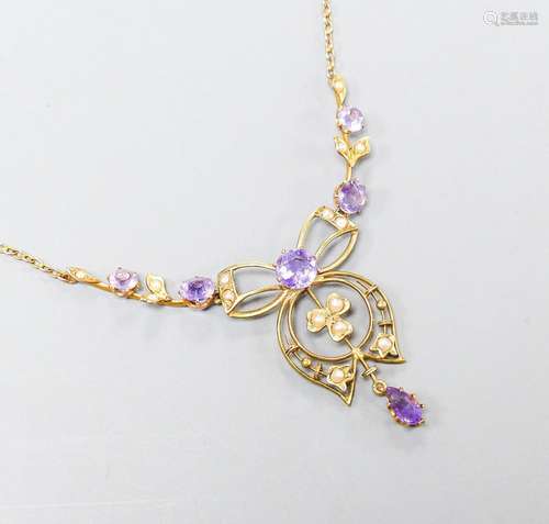 An Edwardian 9ct, amethyst and seed pearl set drop pendant n...