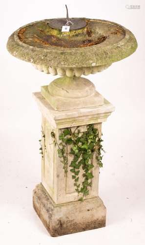 A reconstituted stone garden bird bath combined sundial on s...