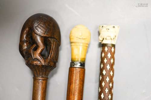 Three various walking canesIncluding two carved Ivory topped...