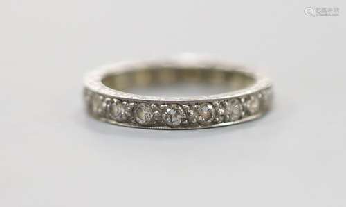 An engraved white metal and diamond set full eternity ring, ...