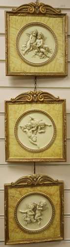 A set of three gilt framed composition plaques27x23cm