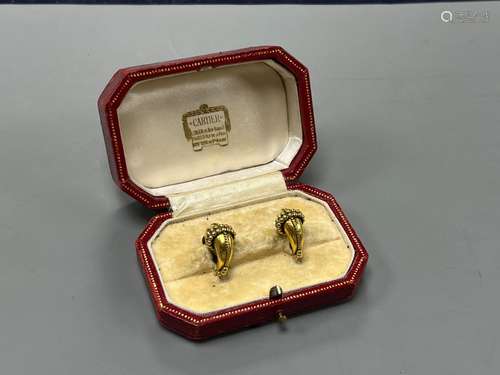 A modern pair of gilt metal earrings, together with a Cartie...