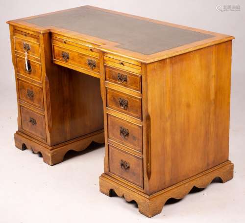 A reproduction yew inverse breakfront kneehole pedestal desk...