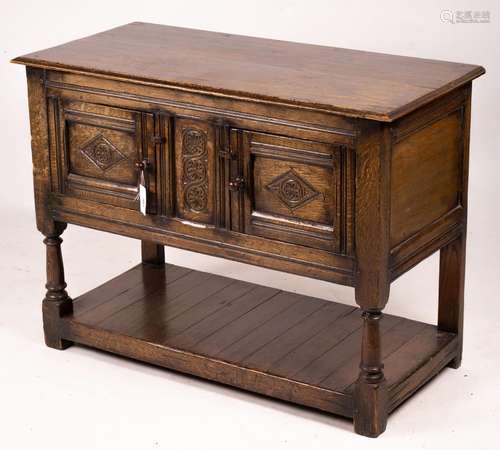 An 18th century style oak two door low cupboard, width 106cm...